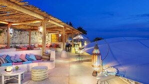 An outdoor seating area with cushioned benches and a pergola overhead. - Karma Luxury 2 bd. VILLA *TOP 5 stars BALi RESORT* (Ungasan)