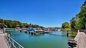 A marina with boats docked, a wooden pier, and a clear blue sky. - Lake Keowee Resort Condo w/ Balcony & Pool Access! (Salem)