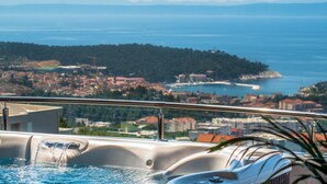 A hot tub with a view of a coastal town and mountains in the background. - Luxury Apartment with Hot tube! Villa Collis (Makarska)