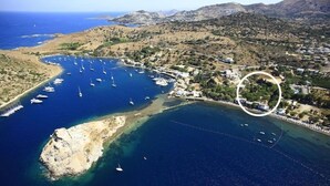 An aerial view of a coastal area with a marina, boats, and residential buildings. - Myndos Bed & Breakfast (Bodrum)