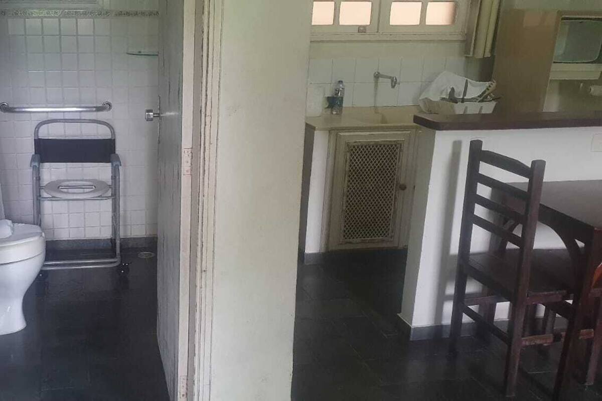 Baño con inodoro, toallero y zona de ducha.