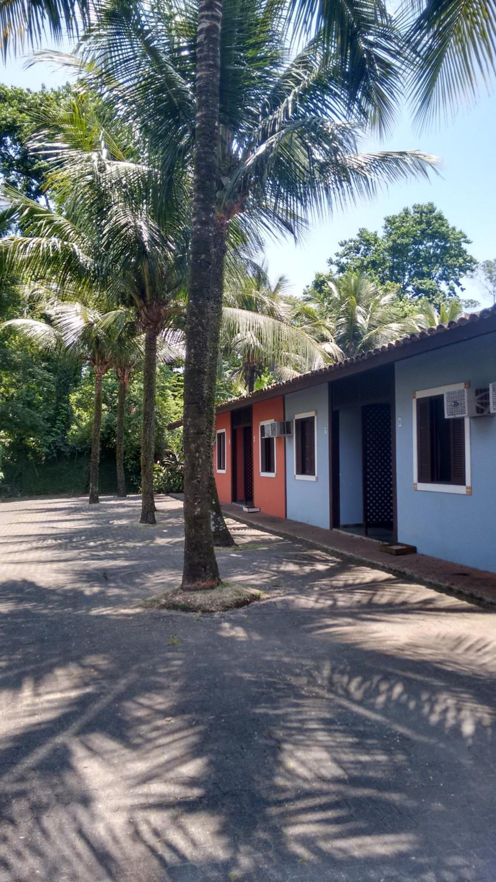 A row of single-story buildings with a paved walkway.