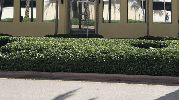 A two-story building with a sign reading "HOTEL PONCE DE LEON." - Hotel Ponce de Leon (Coral Gables)