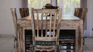 A rustic wooden dining table with a chair in front. - Pipa Casa Eduardo (Tibau do Sul)