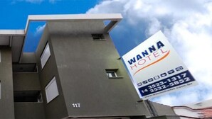 A modern hotel building with a prominent sign for 'Wanna Hotel'. - Wanna Hotel (Lins)