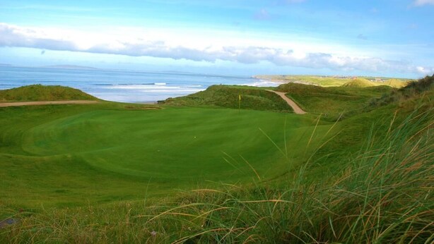 A golf course with a view of the ocean and distant hills. - The 19th Lodge Ballybunion (Ballybunion)