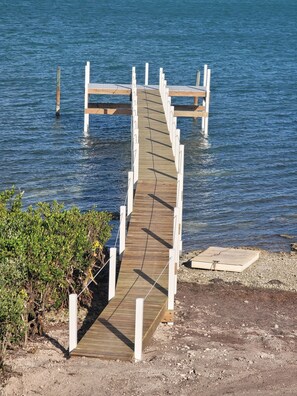 A wooden boardwalk leading to a dock over water. - Keys Beach houses with a daily, rental license. Just remodeled (Summerland Key)