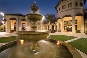 Stunning outdoor space with a central fountain and beautifully manicured lawn.