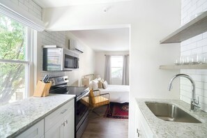 Studio, 1 Queen Bed | Private kitchen | Full-sized fridge, microwave, stovetop, dishwasher