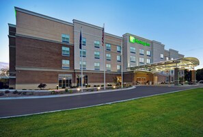A Holiday Inn hotel with a modern design, featuring a covered entrance and a well-maintained lawn. - Holiday Inn Grand Rapids North - Walker by IHG (Grand Rapids)