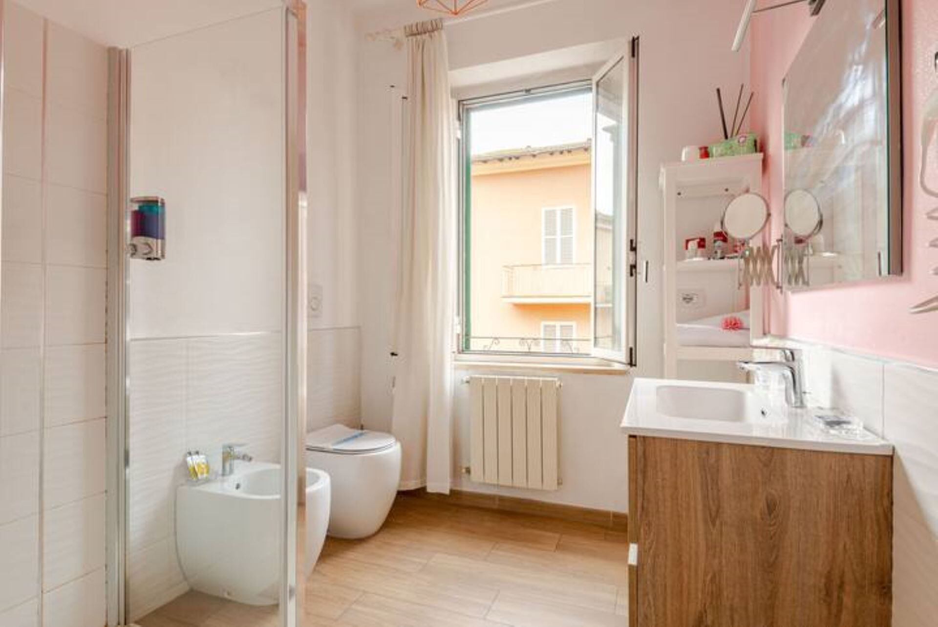 A modern bathroom with a bidet, toilet, and sink.