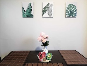 Enjoy the serene ambiance with a beautiful floral centerpiece and stunning botanical prints.