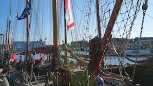 A sailboat named FRANZIS docked at a marina with multiple masts and rigging.