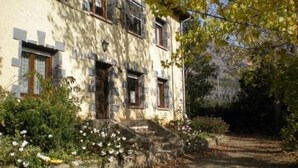 A stone building with multiple windows, a small porch, and a pathway leading to the entrance. - Casa Baltasar, ideal for families and friends, with garden and barbecue. (Isábena)