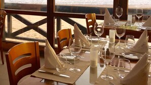A dining table set for two with a view of the ocean. - Stunning ocean view, Prime location, Exclusive design (Lagos)