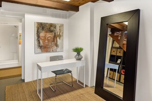 Enjoy a peaceful retreat with a desk for work and a beautiful piece of artwork above.