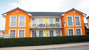 Un edificio de dos pisos con las palabras "Pension" y "Antje" en las fachadas.