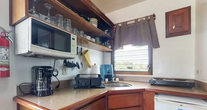 Wood cabana with a porch, pool view, WiFi, and a shared common area with grills