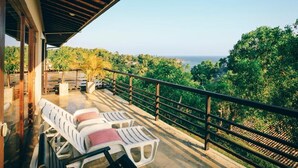 A balcony with white lounge chairs and a view of the ocean. - Highland Villa (Weligama)