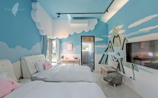 Un dormitorio con cama, escritorio y televisor.