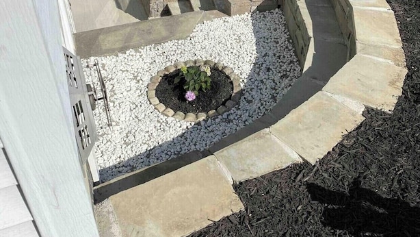 A landscaped garden area with a stone pathway, a central flower bed, and a wooden deck. - Charming, spacious, exceptionally clean & private apt! Ideal Ithaca location! (Ithaca)