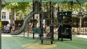 A playground with a slide, climbing structures, and a covered area. - MAMAD Trendy Apt & Balcony on Sheinkin Street by FeelHome (Tel Aviv - Jaffa)