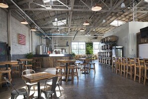 Enjoy dining at a spacious bar with multiple seating options, including bar stools and high chairs.