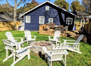 Enjoy a cozy evening by the fire pit surrounded by comfortable Adirondack chairs.