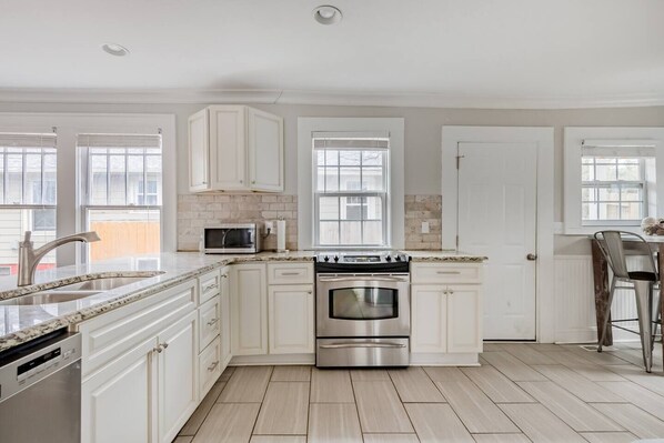 Enjoy cooking in this well-equipped kitchen with a large island, double oven, and sink.
