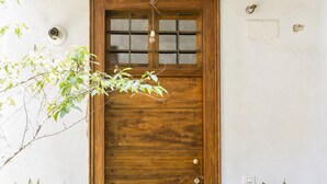 A wooden door with a glass panel and a light fixture above it. - LuxRent Apartment Castello (Torino)