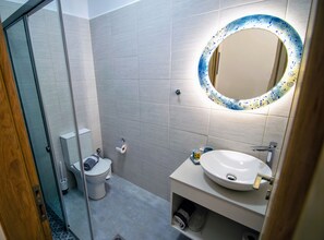 Shower, hair dryer, slippers, towels