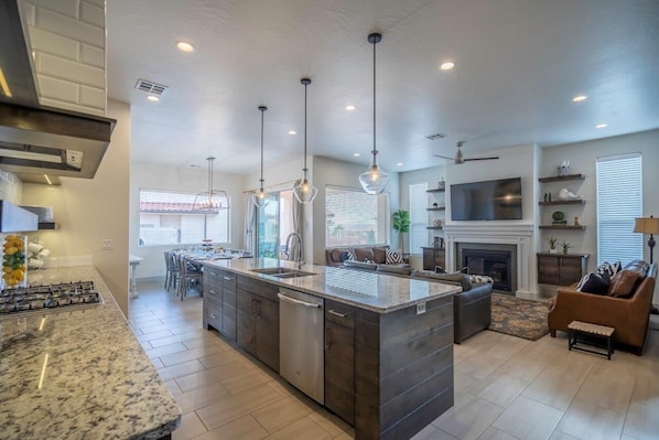 A modern kitchen with a large island, built-in appliances, and pendant lighting. - Arcadia 31 🧡 Private Hot Tub * Arcade Gaming Room * Sleeps 28! (Santa Clara)