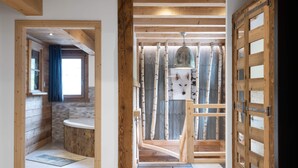 A modern interior with exposed wooden beams, a rustic bathroom, and a unique fox-themed wall decoration.