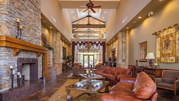 A spacious lobby with a stone fireplace, leather sofas, and a chandelier. - Truly a Las Sendas Resort home! (Mesa)