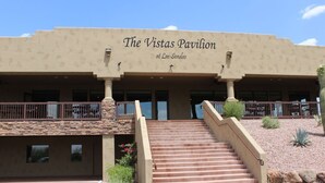The Vistas Pavilion at Las Sendas with a staircase leading to the entrance, a stone facade, and a clear sky. - Truly a Las Sendas Resort home! (Mesa)