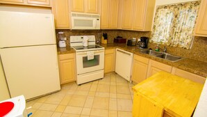 A compact kitchen with light-colored cabinets, a microwave, stove, and a sink. - Beautiful 1½ Bedroom Condo on the Sea of Cortez at Las Palmas Resort D-703A (Puerto Peñasco)