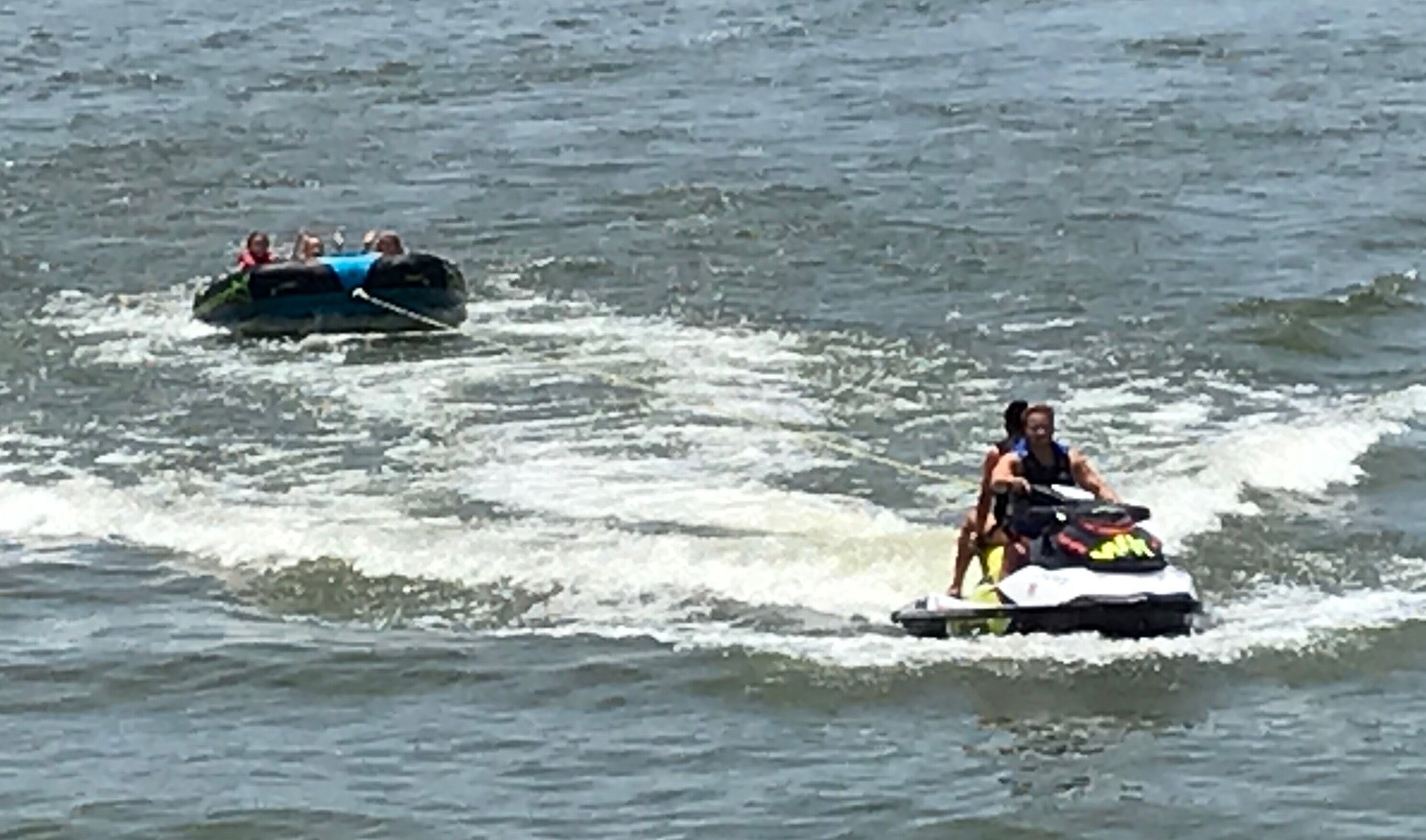 A jet ski on water with a person riding it.