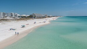 A beach with clear turquoise water, white sand, and a row of beachfront houses. - HUGE % OFF, Private Pool | 6 Bikes ☀️129 Reviews | Gulf Views | Seagrove 30A ☀️Beach Gear (Santa Rosa Beach)