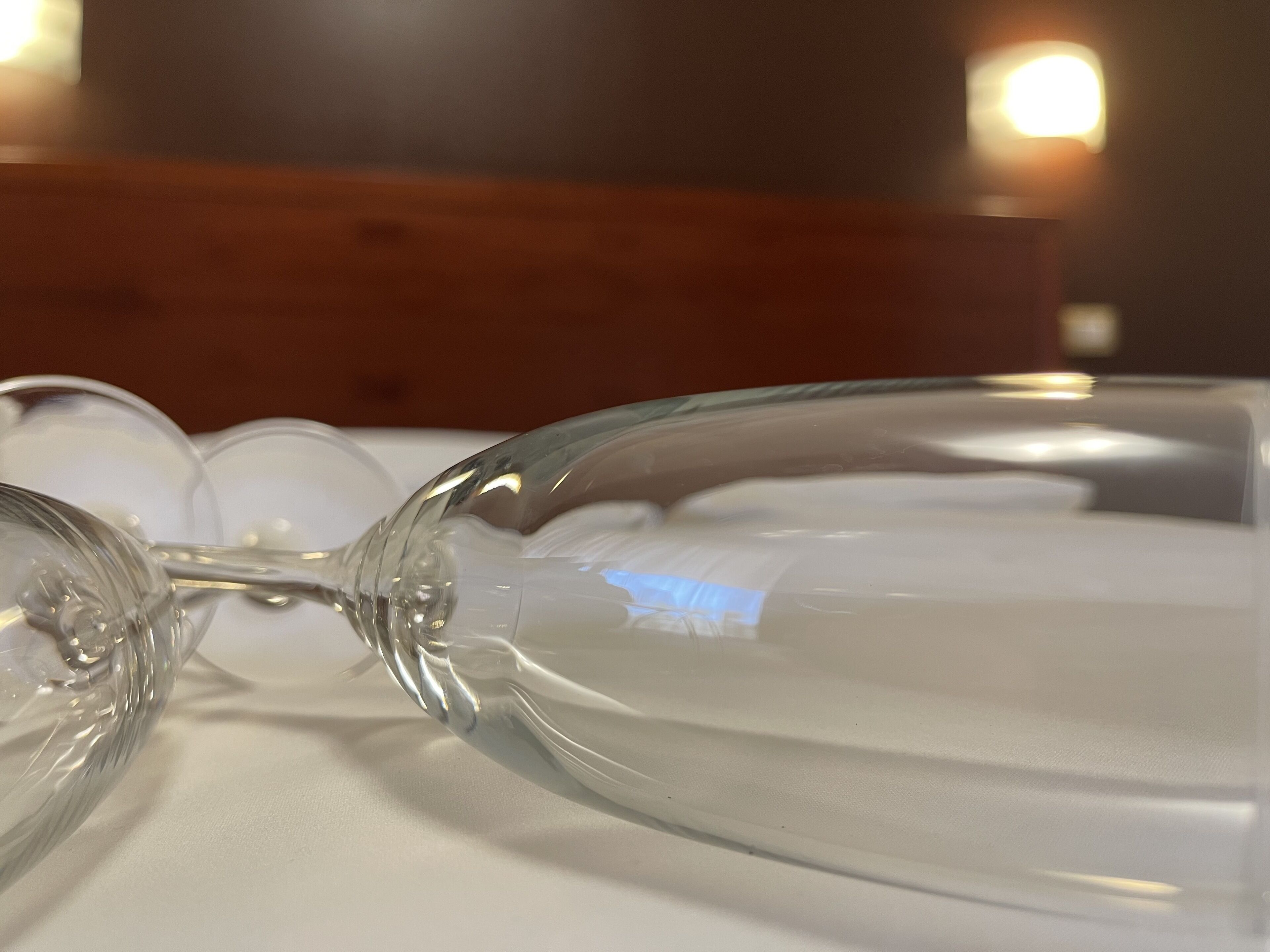 A clear glass of water on a white surface.
