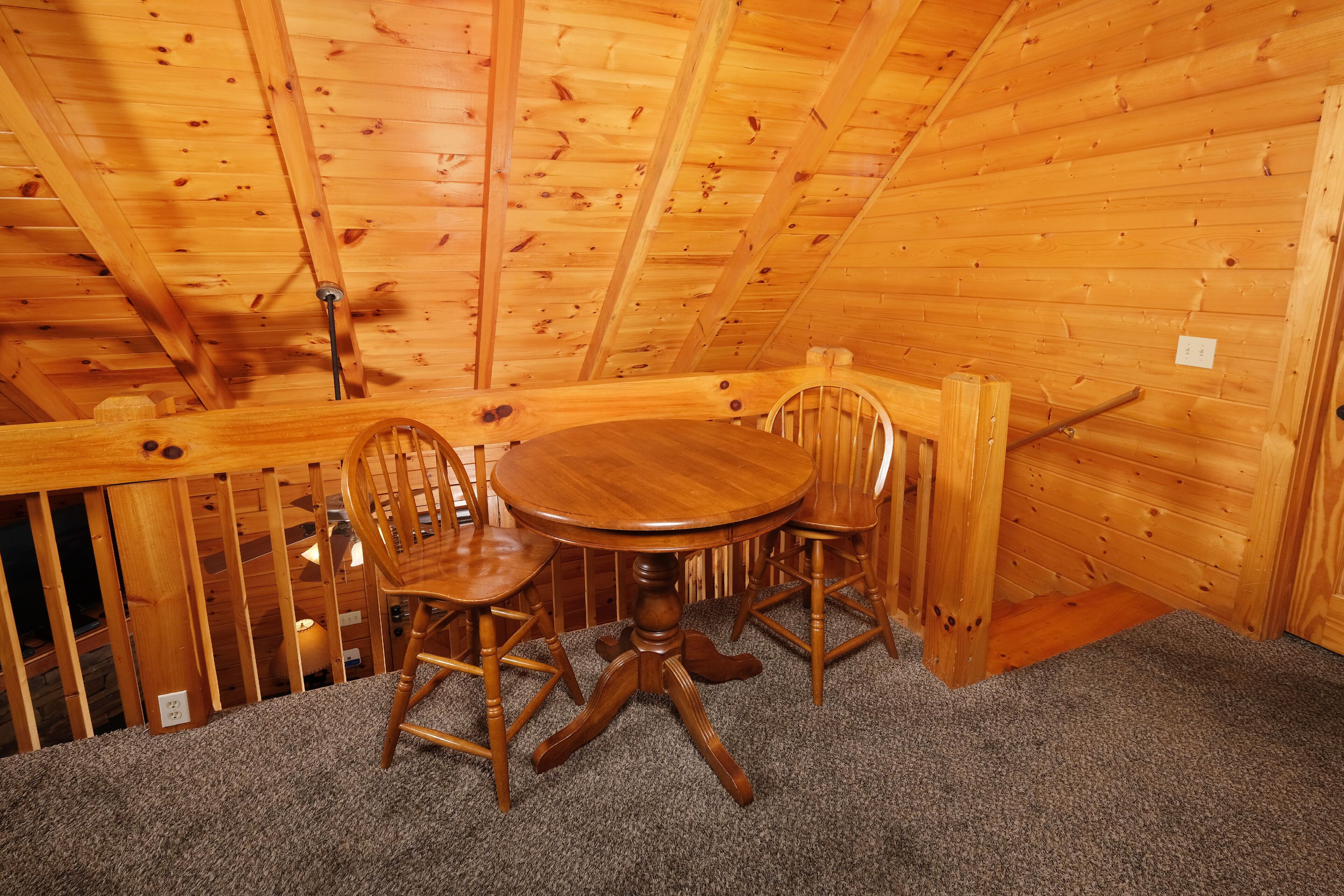 A wooden dining area with a round table and four chairs.