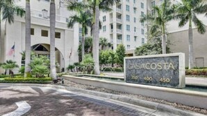 A building with a sign reading "CASACOSTA" and apartment numbers 350, 400, 450. - One bedroom apt just 1 mile to the beach with pool, gym, and playroom! (Boynton Beach)