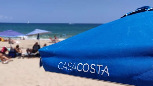 A beach umbrella with "CASACOSTA" written on it. - One bedroom apt just 1 mile to the beach with pool, gym, and playroom! (Boynton Beach)
