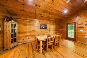 Cozy cabin interior with a dining area, storage cabinet, and a framed picture on the wall.