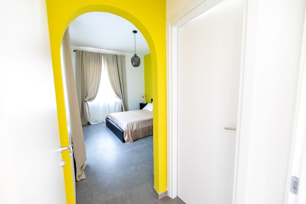 A bedroom with a bed, curtains, and a nightstand. - Monca's House (Vietri sul Mare)
