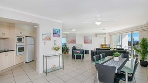 A modern apartment with a kitchen, dining area, and living room. - Ocean Plaza 1467 - Coolangatta Beachfront - Min. 3 Night Stays! (Coolangatta)