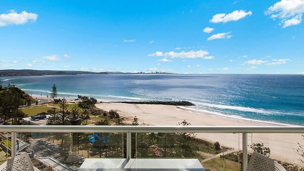 A coastal view from a balcony overlooking a beach with a clear sky. - Ocean Plaza 1467 - Coolangatta Beachfront - Min. 3 Night Stays! (Coolangatta)