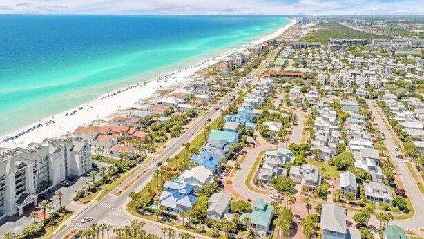 An aerial view of a coastal residential area with a beach, houses, and a large hotel complex. - STEPS TO CRYSTAL BEACH see picture for location (Destin)