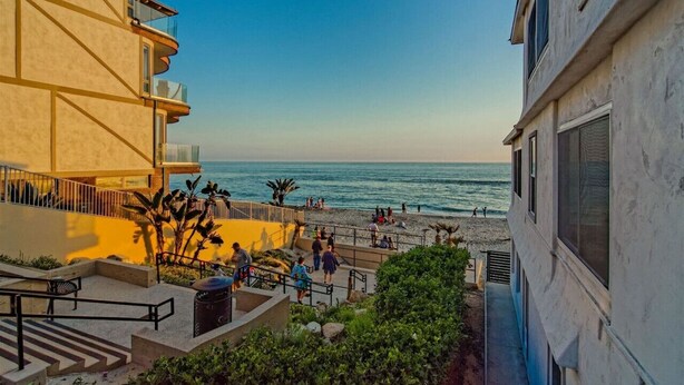 A coastal hotel with a balcony overlooking the beach, a pool area, and a view of the ocean. - Luxury Villa - Studio I (Carlsbad)