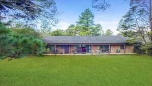 A two-story house with a covered patio area, a brick exterior, and a lawn in front. - Backs Directly Onto Leura Golf Course (LEURA)