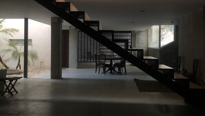 A modern interior with a staircase leading to a dining area. - Single family Home (El Puerto de Sta María)